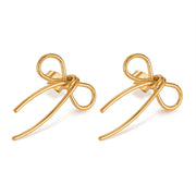 Gold bow-shaped earrings on a white background